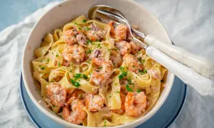 Breite Bandnudeln mit saftigen Garnelen in cremiger Sauce, garniert mit frischer Petersilie. Ein köstliches Gericht mit Nudeln mit Garnelen.