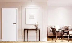 Białe drzwi rewersyjne, konsola z obrazem i wazonem, sofa i stół w jadalni.