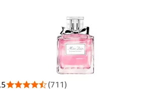 Różowy flakonik perfum Miss Dior Blooming Bouquet z srebrną kokardką, jak kwitnący bukiet wiosennych kwiatów.