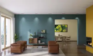 Modernes Wohnzimmer mit zwei Ledersofas, einem Regal und einem Essbereich. Die Wände sind in Petrol und Gelb gestrichen, was zeigt, was ist dispersionsfarbe.