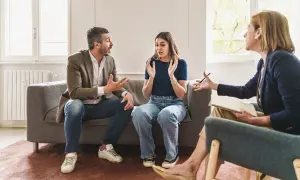 Un couple en thérapie, discutant de problèmes familiaux et d'abus de faiblesse. La thérapeute écoute attentivement.