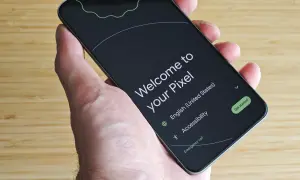 Mano sujetando un Pixel listo para configurar mi dispositivo Android. Pantalla de bienvenida en inglés, con opciones de accesibilidad y llamada de emergencia.