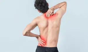 Uomo con dolore alla schiena bassa, evidenziato in rosso. Quanto dura uno strappo muscolare alla schiena bassa?
