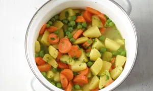Ein Topf mit Kartoffeln, Karotten und Erbsen, ein einfaches und leckeres erbsen rezept.