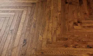 Dettaglio di un pavimento in legno con posa a spina di pesce. Valutare il parquet spina di pesce pro e contro per un tocco di classe.