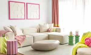Salon moderne avec canapé crème, coussins roses et verts, tables d'appoint colorées. L'association de couleur peinture crée une ambiance joyeuse.