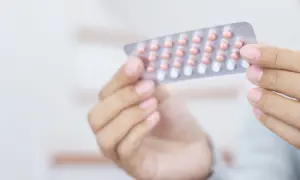 Dłoń trzyma blister z tabletkami antykoncepcyjnymi. Wiele osób szuka informacji o tabletki antykoncepcyjne nazwy.