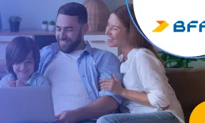 Rodzina ogląda coś na laptopie, uśmiechnięta. Logo BFF w rogu.
