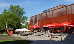 Kraków Klub Studio z czerwonymi parasolami Coca-Cola i schodami prowadzącymi do wejścia.