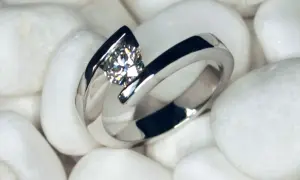 Anillo de oro blanco con diamante, sobre piedras blancas. La joya perfecta para elegir las piedras para anillos de compromiso.