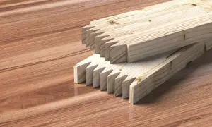 Dos tablas de madera con cortes en forma de dientes de sierra listas para unir tablero.