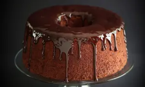 Delizioso chiffon cake al cioccolato con glassa fondente che cola.