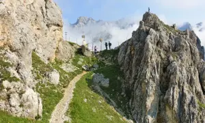 Wanderer auf der Gatterl Tour zur Zugspitze genießen den Ausblick auf felsige Gipfel und Wolkenmeere.
