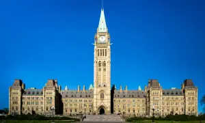Das Parlamentsgebäude in Ottawa, ein Wahrzeichen der Stadt, ragt majestätisch unter blauem Himmel auf.
