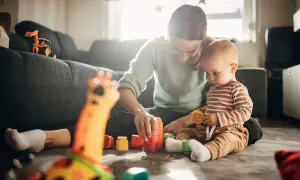 Mama i 7-miesięczne dziecko budują wieżę z kolorowych klocków. Radość i nauka podczas wspólnych zabaw.