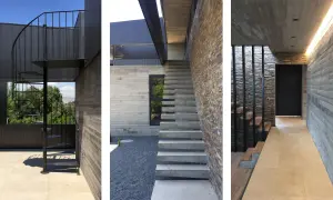 Scale esterne bellissime in metallo nero e cemento, con un design moderno che si integra perfettamente con la pietra naturale e il legno.