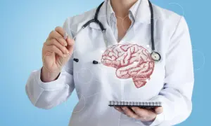 Un médecin en blouse blanche, stéthoscope autour du cou, pointe un cerveau schématisé. Il soigne ce que soigne un neurologue.