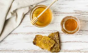 Miód w słoiku i miseczce, plastry miodu. Czy miód to substytut? Nie, to naturalny słodki produkt.