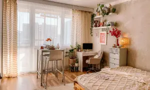 Idee per arredare una casa piccola: un angolo studio, un tavolo alto per mangiare e un letto accogliente, tutto in uno spazio compatto.