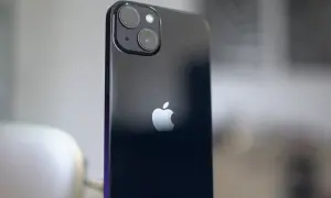 Arrière d'un iPhone 13, avec son logo Apple et le module photo incluant un objectif grand angle.