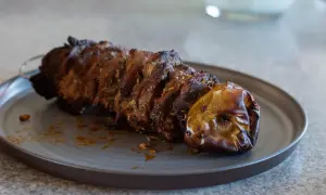 Saftigt kött på spett, perfekt för ett gyros recept. En ugnsbakad äpple ligger bredvid.