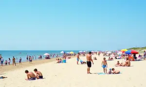 Tłum ludzi na plaży, idealne miejsce na wakacje. Gdzie najbliżej nad morze z Warszawy? Tutaj!