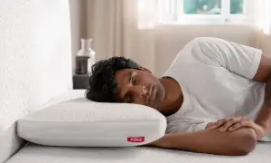 A man sleeps soundly on a white pillow, enjoying a peaceful rest. This image reassures that bamboo pillows are not toxic.