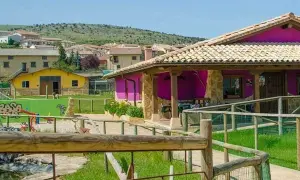 Un lugar ideal para rutas por Estella con niños: un parque infantil y una casa rural colorida.