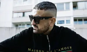 Ein Mann mit kurzgeschorenem Haar und Sonnenbrille, der die Rap-Szene repräsentiert.