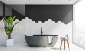 Bagno moderno con vasca scura e piastrelle esagonali bianche. Idee per dipingere piastrelle bagno: contrasto tra nero e bianco.