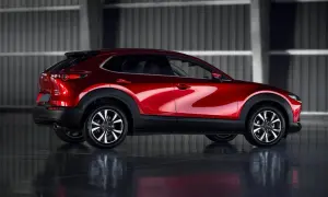 Błyszczący czerwony Mazda CX-30 z profilu. Poznaj jego kompaktowe mazda cx 30 wymiary, idealne do miasta.