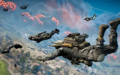 Żołnierze skaczą ze spadochronami nad płonącym polem bitwy. To intensywny battlefield battle royale.