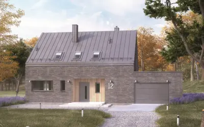 Nowoczesny dom typu stodoła z kamienną elewacją i metalowym dachem, otoczony jesienną przyrodą.