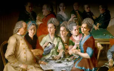 En grupp människor samlas runt ett bord för att dricka kaffe, en scen som speglar kaffets historia och dess sociala betydelse.