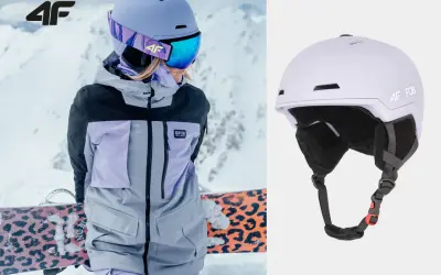 Męski kask narciarski 4F w kolorze liliowym, idealny na stok. Widoczny na zdjęciu z narciarką w kurtce 4F.