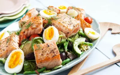 En härlig sallad nicoise med lax, ägg, gröna bönor och oliver. Perfekt för en lätt lunch.