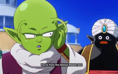 Zielony kosmita z antenkami i czarny Mr. Popo w turbanie rozmawiają.