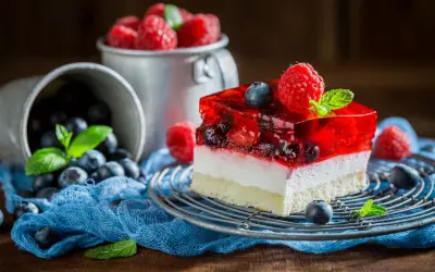 Kolorowy deser z galaretką i owocami leży na talerzyku. Zastanawiasz się, dlaczego galaretka z owocami nie tężeje?