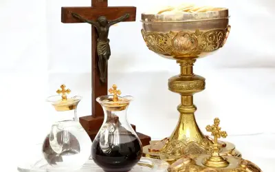 Kielich, krzyż i ampułki z winem i wodą. Zastanawiasz się, ile kosztuje msza za zmarłego?