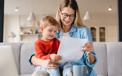 Mama z synkiem aktywnie w domu dla kogoś, przeglądają dokumenty.