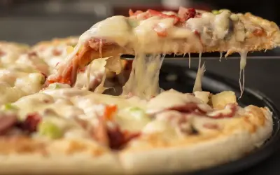 Rozciągający się ser z kawałka pizzy, idealny na festiwal pizzy.