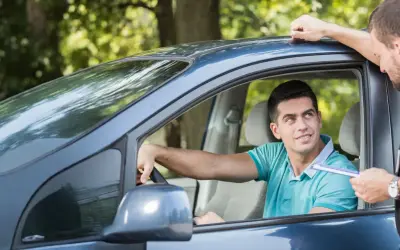 Agente mostra un verbale a un automobilista, forse per assicurazione scaduta e multa.