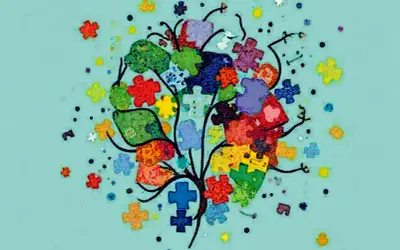 Kolorowe puzzle tworzą drzewo, symbolizując złożoność i różnorodność w kontekście autyzmu. Statystyki pokazują, jak wiele osób jest dotkniętych.