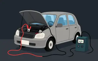 Ładowanie akumulatora w samochodzie bez zdejmowania klem jest możliwe. Widać to na ilustracji, gdzie kable rozruchowe są podłączone do akumulatora.