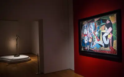 A museum gallery showcases Picasso's "Les Femmes d'Alger" alongside a slender bronze sculpture.