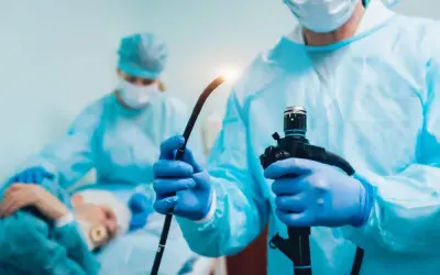 Lekarz w rękawiczkach przygotowuje endoskop do gastroskopii i kolonoskopii za jednym razem NFZ.