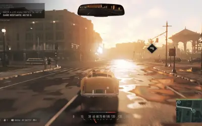 Conduciendo un coche clásico en una calle mojada, con el sol del atardecer iluminando la ciudad. El objetivo actual en Mafia 3 es eliminar a los asaltantes de Artie.