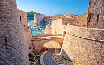 Dubrovniks gamla stad, känd från Game of Thrones, med sina imponerande stenmurar och en pittoresk hamn full av båtar.