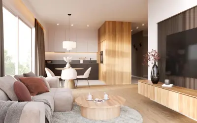 Przytulny salon z elementami stylu japandi: jasna sofa, drewniany stolik kawowy, kuchnia z wyspą i jadalnia.