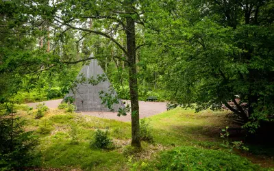 En grå pyramid reser sig ur en lummig skog. En perfekt plats för udda utflykter i Småland, med bänkar för vila.